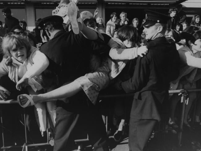 1968: Police attempt to hold back fans as The Monkees arrive for the start of their Australian tour at Kingsford Smith Airport, Sydney, Picture: Ron Iredale/File