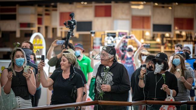 Anti-lockdown protesters sing in Chadstone Shopping Centre during a brief protest on Sunday. Picture: Darrian Traynor/Getty Images.