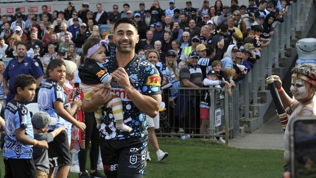 Sharks halfback Shaun Johnson walks out in his 200th NRL match. Moments later he went over to say hi to Denzel (far right).