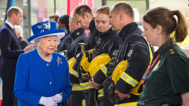 Britain'Queen Elizabeth II meets firefighters during a visit to the Westway Sports Centre, the temporary shelter for those who have been made homeless in the Grenfell Tower disaster, June 16 2017. Picture: Dominic Lipinski, AFP