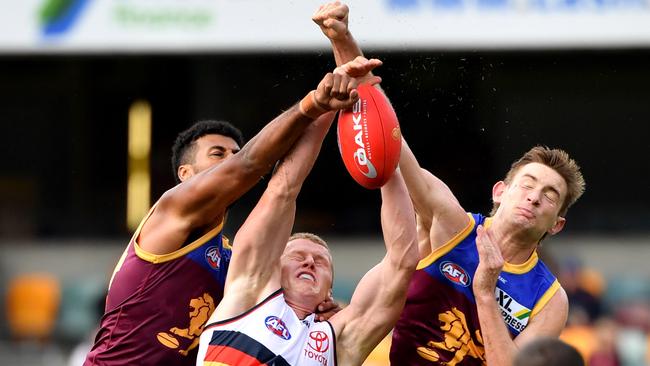 Crows ruckman Reilly O’Brien contests the ball with the Lions’ Archie Smith and Harris Andrews. Picture: AAP Image/Darren England