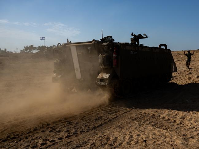 An IDF soldier guides an armoured personnel carrier in southern Israel. Picture: Getty Images