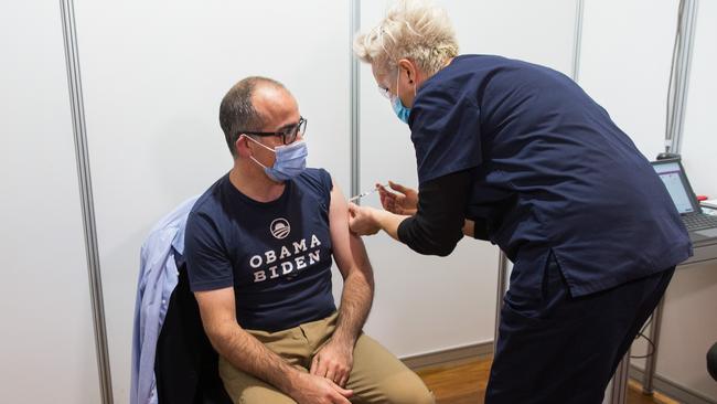 Acting Premier James Merlino rolls up his sleeve for a vaccine on Friday.