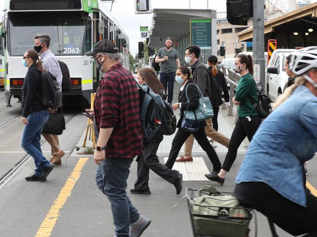 Traffic and workers return to Melbourne CBD after 50% of workers are allowed back to work after the COVID restrictions. People on Swanston Street. Monday, January 18, 2020. Picture: David Crosling