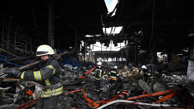 Rescuers clear the rubble of a warehouse containing more than 50,000 tons of deep-frozen food in the town of Brovary, north of Ukrainian capital of Kyiv. Photo by Genya SAVILOV / AFP