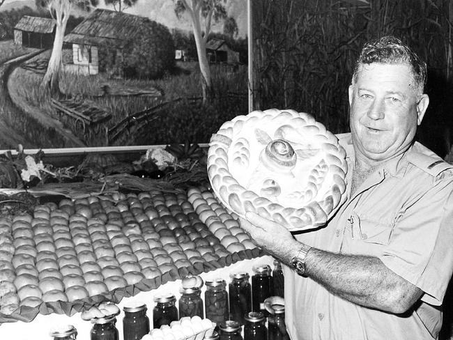 Townsville prison farm assistant farm supervisor Jack McIntosh shows off a loaf of bread made at the prison, at a stand at an agricultural show in 1980. Picture: Townsville Bulletin