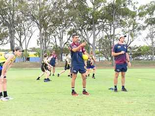 ON TRACK: Brisbane Lion Charlie Cameron instructs a group with fellow Lion Corey Lyons at Shalom College. Picture: Shane Jones