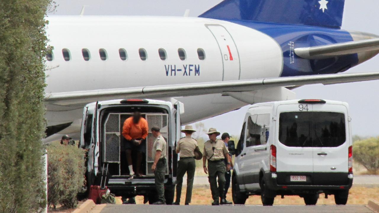 Prisoners prepare to board a chartered flight to Darwin at Alice Springs Airport. Picture: Gera Kazakov