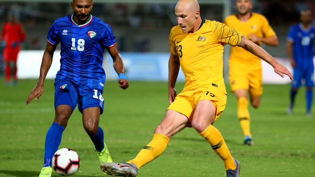 Socceroo Aaron Mooy takes on Kuwait’s Amer Almatoug Alfadhel
