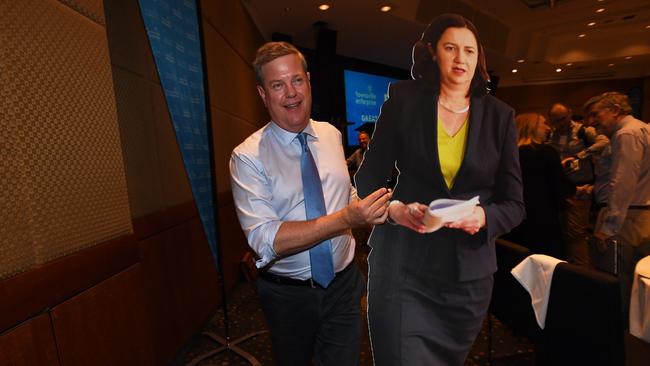 Queensland Opposition Leader Tim Nicholls carries a cardboard cutout of Queensland Premier Annastacia Palaszczuk at the Townsville leaders forum. Picture: AAP.