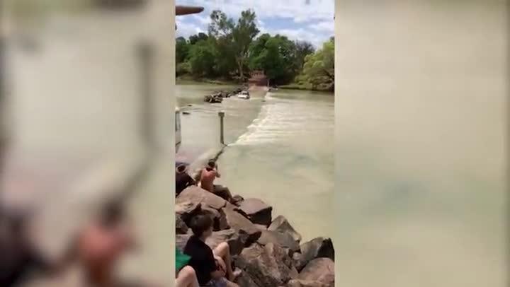 A motorist takes on the croc-infested waters of Cahill's Crossing