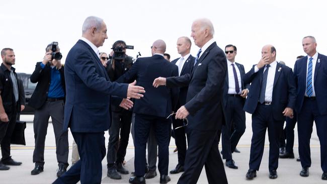 Israel Prime Minister Benjamin Netanyahu (L) greets US President Joe Biden upon his arrival at Tel Aviv's Ben Gurion airport on two weeks after the October 7 massacre. Picture: AFP.