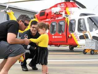 SPREADING THE LOVE: Josh and Bella Joy Cleary meet with Westpac Life Saver Rescue Helicopter pilot John Walker after donating money to the lifesaving organisation which airlifted Mr Cleary's wife Renee to the Gold Coast following a brain haemorrhage. Picture: Marc Stapelberg