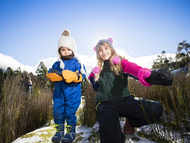 Aurora, 2, and Isabella Braham, 7, enjoying the snow on Mt Wellington/kunanyi. Picture: RICHARD JUPE