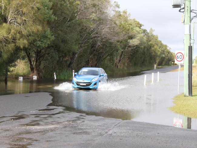 A car negotiates water over Carrs Drive at Yamba. Picture: Rodney Stevens.