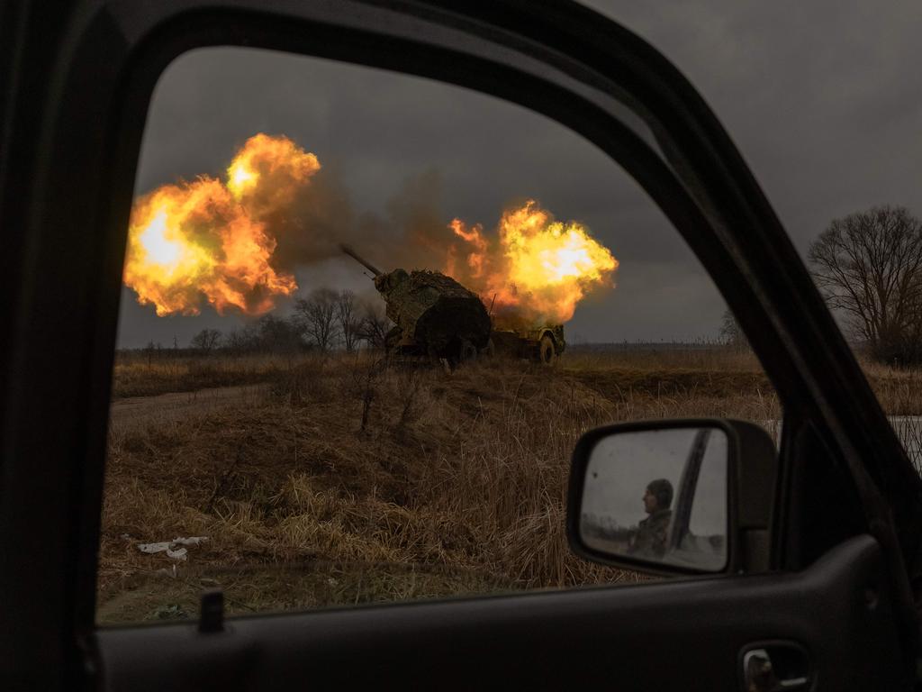 TOPSHOT - -- AFP PICTURES OF THE YEAR 2024 -- A Ukrainian soldier reflected in a car mirror looks on as a Swedish-made Archer Howitzer operated by Ukrainian members of the 45th Artillery Brigade fires towards Russian positions, in the Donetsk region, on January 20, 2024, amid the Russian invasion of Ukraine.Â  (Photo by Roman PILIPEY / AFP) / AFP PICTURES OF THE YEAR 2024