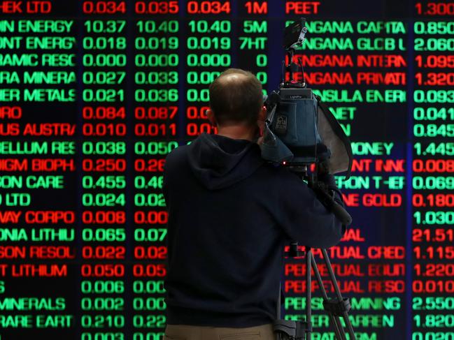 SYDNEY, AUSTRALIA - AUGUST 06: A TV camera person records electronic boards displaying stock information at the Australian Securities Exchange, operated by ASX Ltd. on August 06, 2024 in Sydney, Australia. The markets are closely attuned to the RBA's next rates decision, with inflation persisting even as rates have been elevated for an extended time after the end of the COVID-19 pandemic. (Photo by Lisa Maree Williams/Getty Images)