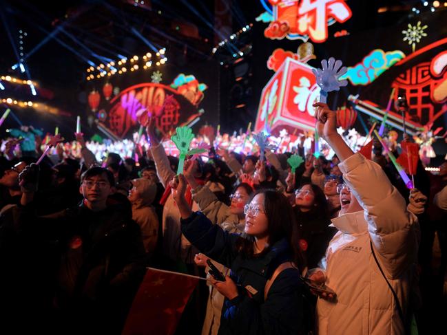 Revellers gather to usher in the New Year in Beijing on December 31, 2023. Picture: Pedro Pardo / AFP