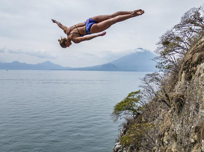 Rhiannan Iffland of Australia dives from the cliff at Bahia De Patzisotz with San Pedro volcano in the background during the Red Bull Cliff Diving World Series "Dive into Guatemala" at Lake Atitlan, Guatemala on April 20, 2023. // Dean Treml / Red Bull Content Pool // SI202305210363 // Usage for editorial use only //