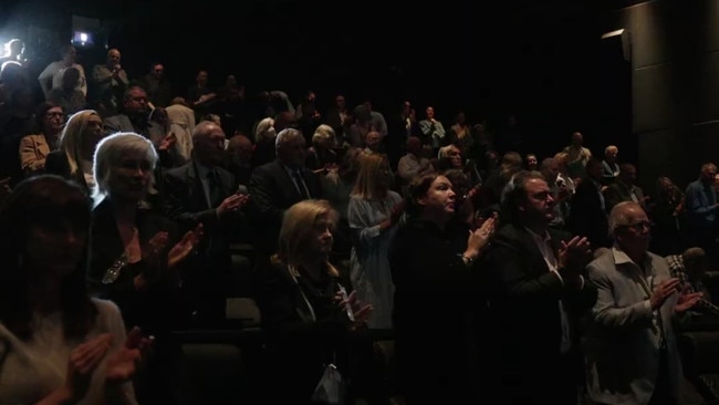 People at Patrick's memorial giving him a standing ovation after he died.