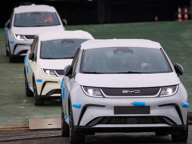 Electric vehicles of Chinese car manufacturer BYD leave the car carrier ship BYD Explorer No. 1 which is moored at the automotive terminal of operator BLG at the port of Bremerhaven, Germany, on February 26, 2024. The vessel is chartered by BYD and delivers about 3,000 BYD cars to Bremerhaven during its maiden call at Germanyâs most important port for cars. (Photo by FOCKE STRANGMANN / AFP)