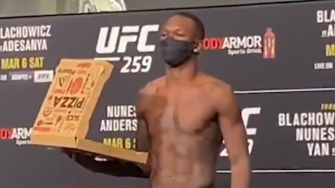 Israel Adesanya posed with a box of pizza. Credit: @marc_raimondi