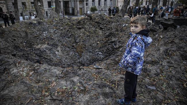 KYIV, UKRAINE - OCTOBER 10: People gather around a hole at Taras Shevchenko Park formed after Russia's airstrike on Monday, October 10, 2022 in Kyiv, Ukraine. (Photo by Metin Aktas/Anadolu Agency via Getty Images)