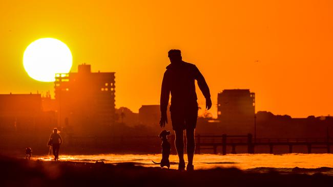 Sunrise at Port Melbourne Beach ahead of a sweltering day. Picture: Jason Edwards