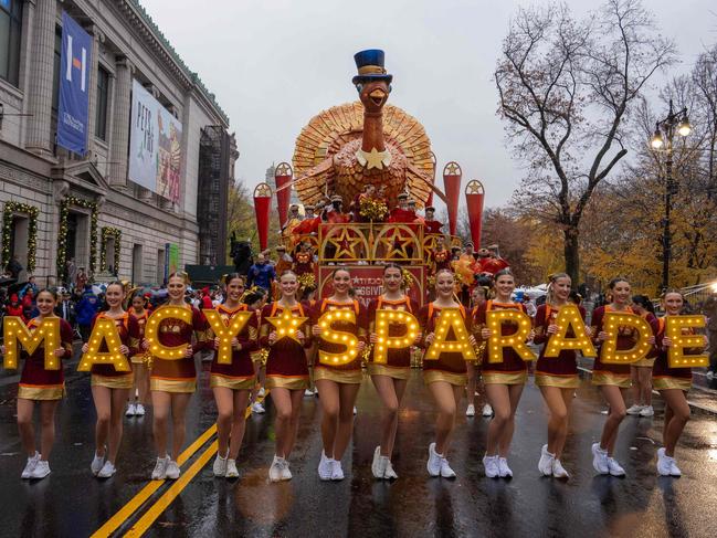 Cheerleaders perform in the rain during the annual Macy's Thanksgiving Day Parade in New York City. Picture: AFP