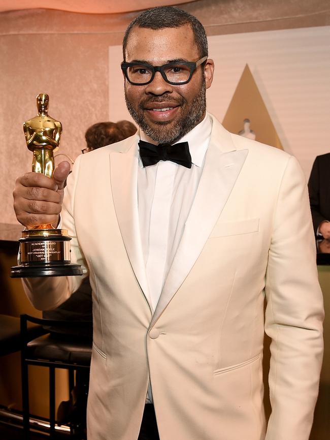 Best Original Screenplay winner Jordan Peelegets to grips with his Oscar. Picture: Kevork Djansezian/Getty Images/AFP