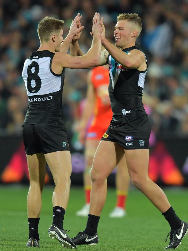 Hamish Hartlett celebrates a goal with Dan Houston against the Suns in Round 23. Picture: AAP Image/David Mariuz