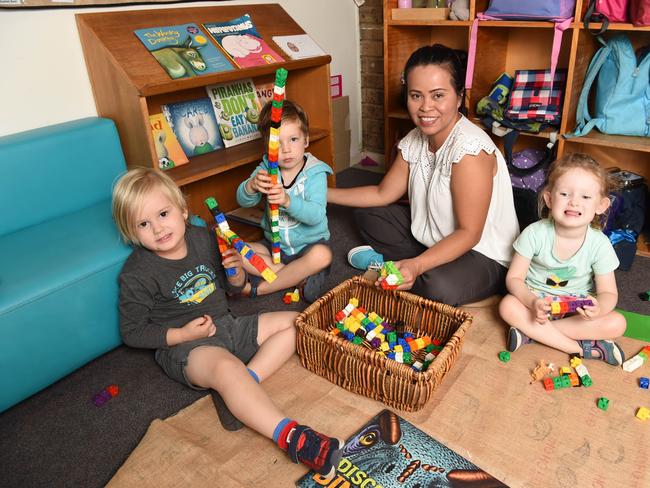 Emma Mclean Kindergarten lead educator Elizabeth Leading plays with Ethan, Harrison and Scarlett. Picture: Lawrence Pinder