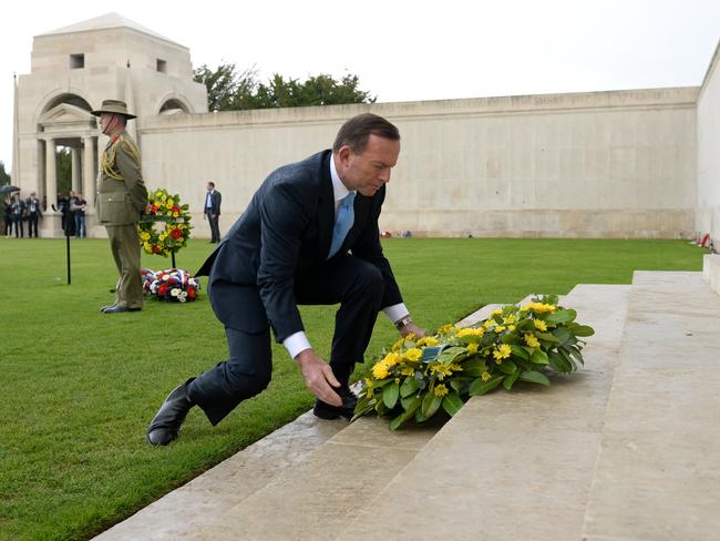 Tony Abbott, then-prime minister, lays a wreath at the Australian National Memorial in Villers-Brettoneux in 2014. Picture Jake Nowakowski