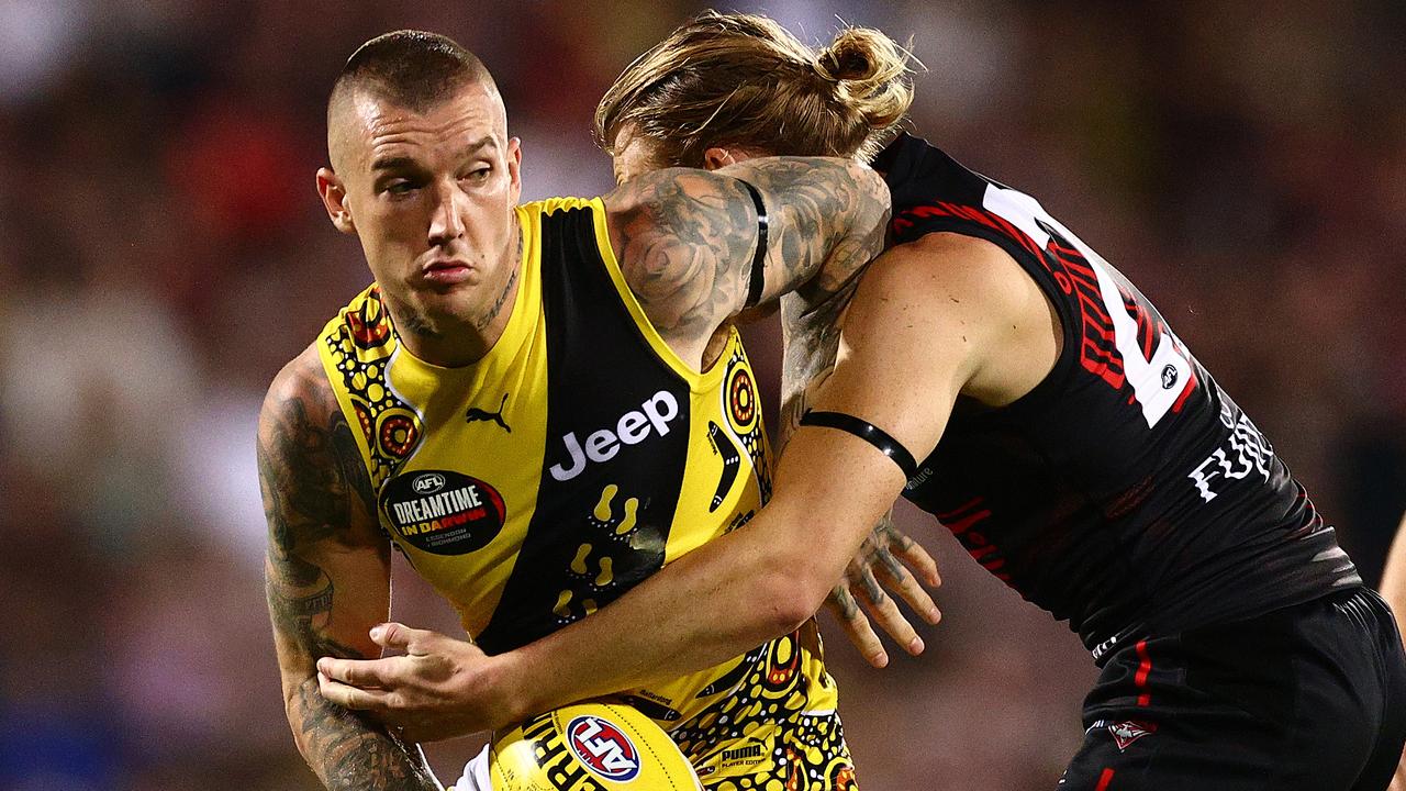 DARWIN, AUSTRALIA - AUGUST 22: Dustin Martin of the Tigers is challenged by Mason Redman of the Bombers during the round 13 AFL match between the Essendon Bombers and the Richmond Tigers at TIO Stadium on August 22, 2020 in Darwin, Australia. (Photo by Daniel Kalisz/Getty Images)