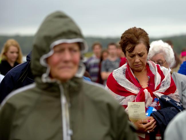 A woman bows her head in prayer during 13th anniversary ceremonies commemorating the September 11th attacks at the Wall of Names at the Flight 93 National Monument in Shanksville, Pennsylvania. Picture: Jeff Swensen