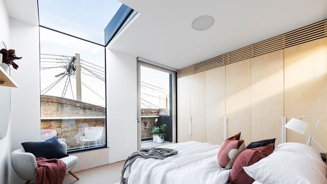 The main bedroom provides district from off the balcony and a partial glass ceiling.