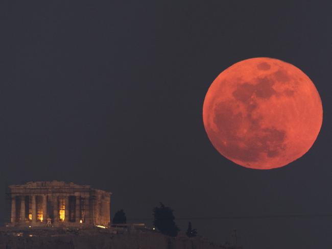 The moon rises behind the 2500-year-old Parthenon temple on the Acropolis of Athens, Greece. Picture: AP