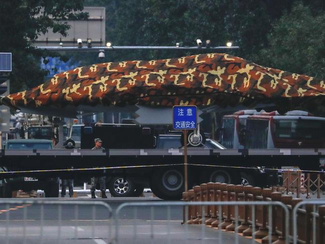 A Chinese military vehicle possibly carrying a drone passes along the Jianguomenwai Avenue in Beijing, Saturday, Sept. 21, 2019. Many of the streets in the central part of China's capital were being shut down this weekend for a rehearsal for what is expected to be a large military parade on Oct. 1 to commemorate the 70th anniversary of Communist China. (AP Photo/Andy Wong)