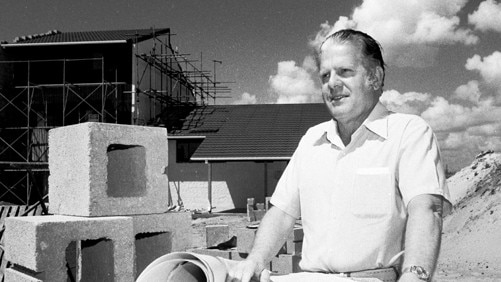 GCB Alderman John Robert (Jock) McIlwain, with plans at a construction site, Gold Coast, Queensland, circa 1970s Picture: A. L. Lambert. Photo supplied by the Gold Coast Local Studies Library.