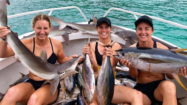 Crows AFLW players Nikki Gore, Chelsea Randall and Angela Foley catch fish during their trip to Nauru. Picture: Supplied, Adelaide Crows