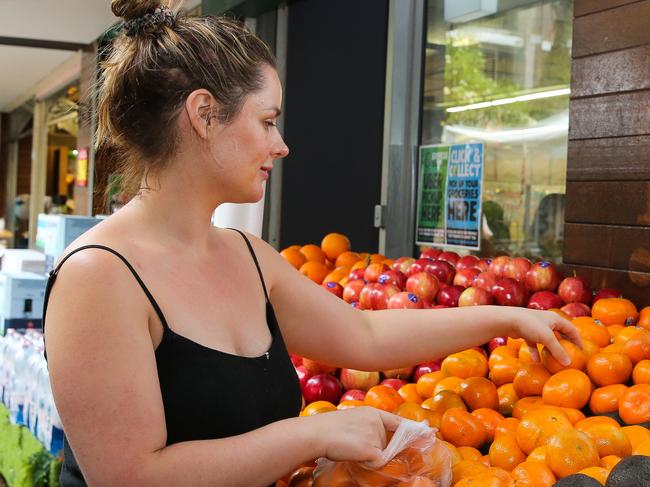 SYDNEY, AUSTRALIA -  Newswire Photos MARCH 14 2023 - A member of the public is seen buying produce and groceries in Sydney as the Cost of living continues to rise. Picture: NCA Newswire / Gaye Gerard.