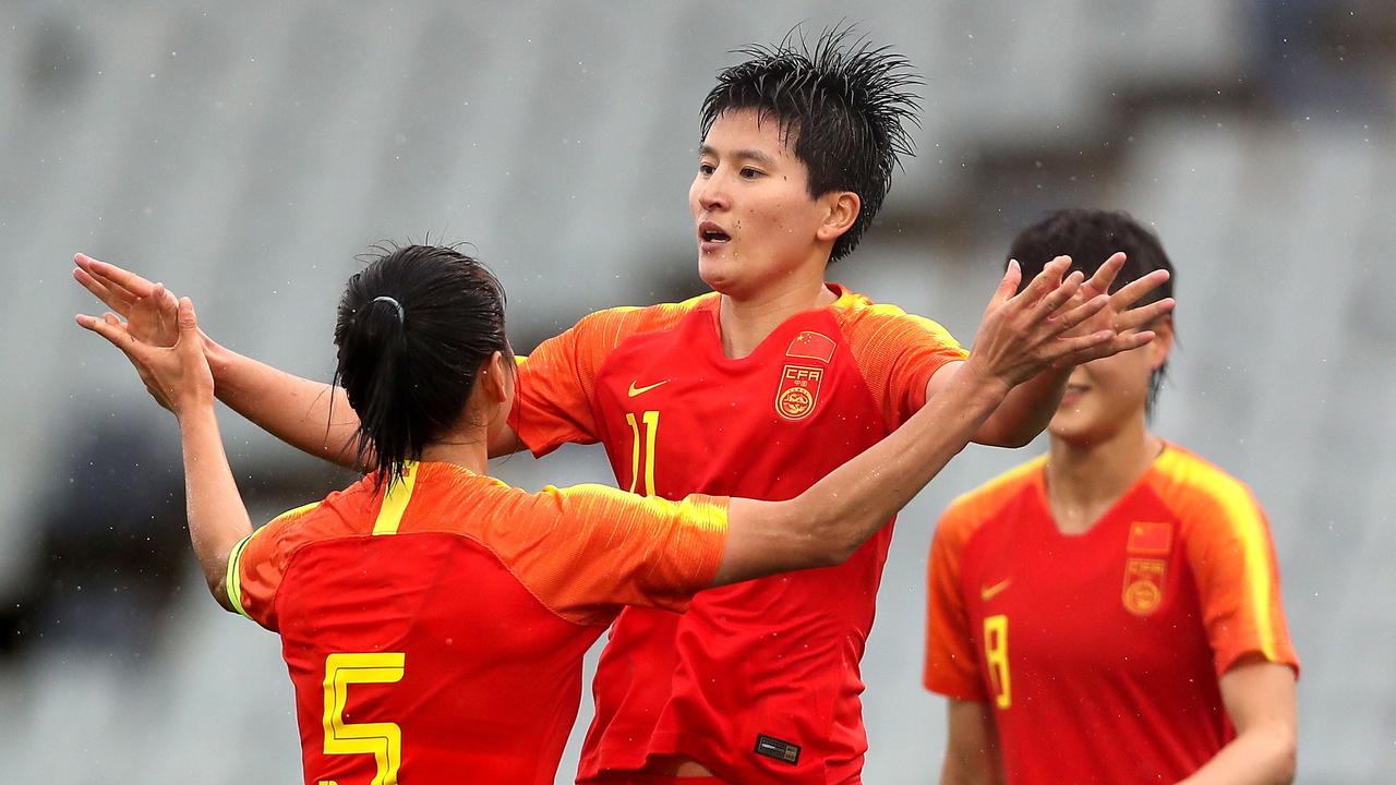 China’s Wang Shanshan (C) celebrates one of China’s six strikes against Thailand.