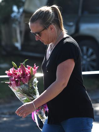 A lady arrives to lay flowers at the scene. Picture: Nicole Garmston