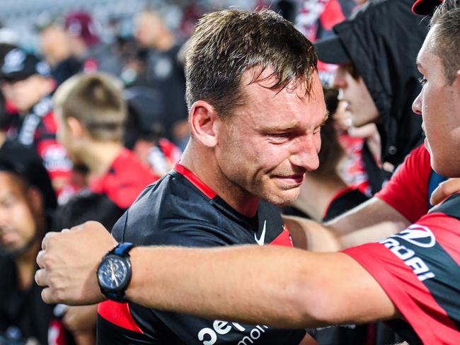 A crying Brendon Santalab of the Wanderers is consoled by Wanderers fans.