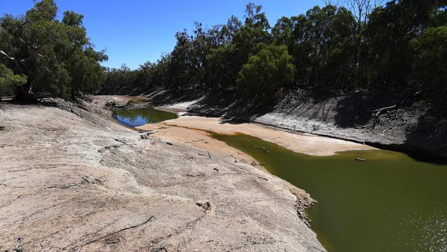 The dry river bed of the Darling River on sheep farmer Wayne Smith's property near Pooncarie, NSW. Picture: AAP Image/Dean Lewins