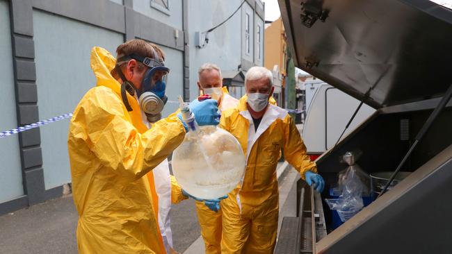 Police pictured carrying what looked like a <i>Breaking Bad</i>-esque meth cooker from the establishment. Picture: Alex Coppel.