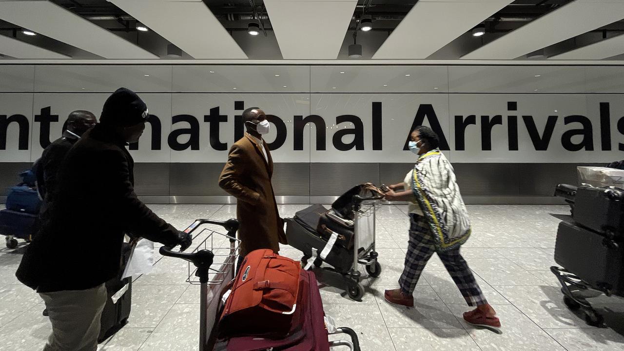 International passengers walk through the arrivals area at Terminal 5 at Heathrow Airport on Friday in London after the heavily-mutated new variant of the Covid-19 virus was detected. Picture: Leon Neal/Getty Images