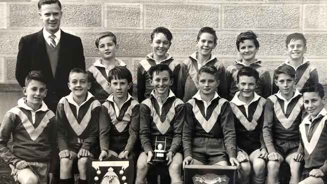 Jeff McMullen seated holding the framed shield fifth from the left.