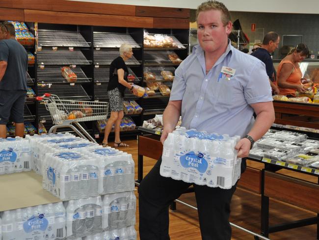 Bowen Supa Iga store manager Andrew Dasecke unpacking extra water in preparation for Cyclone Debbie. Mr Dasecke said the store also ordered extra batteries, long-life milk and canned stock but by 10am Sunday most of it had gone.