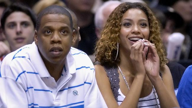 Recording artists Jay-Z, left, and Beyonce watch the New Jersey Nets beat the Indiana Pacer, 92-86, during first round NBA playoffs basketball Tuesday night, May 2, 2006 in East Rutherford, N.J. (AP Photo/Bill Kostroun)